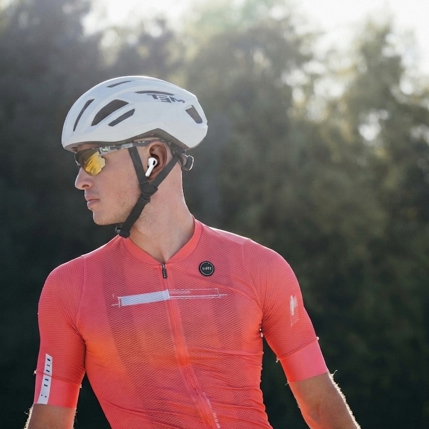 AirPods and iPhone near indoor training equipment, heart rate bridging to receivers