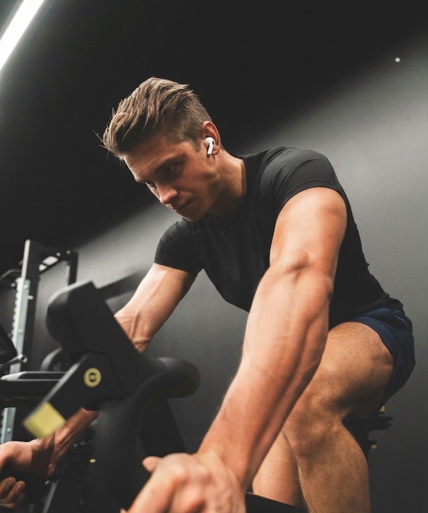 AirPods Pro and iPhone near indoor training equipment, heart rate bridging to receivers